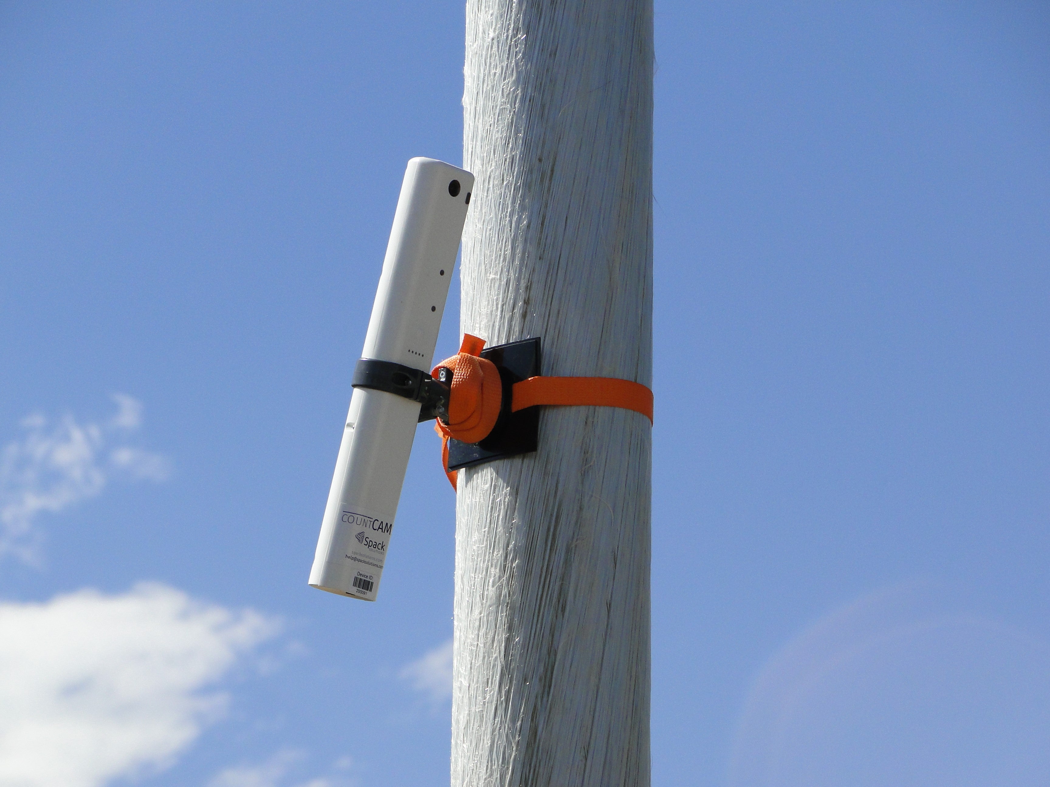 a countCAM3+ mounted to a light pole with a modified mount and orange ratchet.