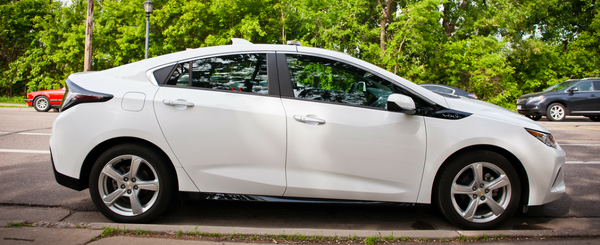 A white Chevy Volt sedan pictured from the passenger side